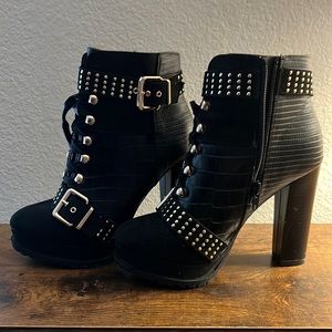These are block heeled boots. With side zippers and detailed buckles.